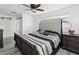 Bedroom with a tufted headboard bed, ceiling fan, and natural light from the window creates a comfortable atmosphere at 1666 N Dakota Ne Ave, St Petersburg, FL 33703