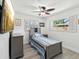 This is a cozy bedroom featuring wood laminate flooring, a ceiling fan, and attractive furnishings at 1666 N Dakota Ne Ave, St Petersburg, FL 33703