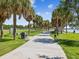 Scenic park path lined with palm trees, offering a serene place for walking, biking, and enjoying the outdoors at 1666 N Dakota Ne Ave, St Petersburg, FL 33703