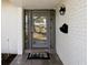 Close-up of front door with gray tile and a 'Welcome' mat in a white brick entryway at 1666 N Dakota Ne Ave, St Petersburg, FL 33703
