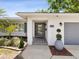 Inviting front entrance with gray tile floor, brick accents, fresh landscaping, and modern fixtures at 1666 N Dakota Ne Ave, St Petersburg, FL 33703