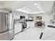 Bright white kitchen featuring stainless steel appliances, marble countertops, and a seamless transition to the dining area at 1666 N Dakota Ne Ave, St Petersburg, FL 33703