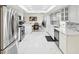Spacious modern kitchen with white cabinetry, stainless appliances, marble flooring, and a lovely dining area at 1666 N Dakota Ne Ave, St Petersburg, FL 33703