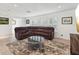 Inviting living room with large sectional sofa, modern decor, and light-filled windows with plantation shutters at 1666 N Dakota Ne Ave, St Petersburg, FL 33703