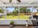 This screened-in patio shows a beautiful view of the fenced backyard, offering a private and serene outdoor space at 1666 N Dakota Ne Ave, St Petersburg, FL 33703