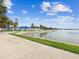 Peaceful waterfront view with a walking path along the shoreline under a sunny sky at 1666 N Dakota Ne Ave, St Petersburg, FL 33703