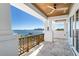 A covered outdoor terrace features elegant columns, wooden railing, and views of the water at 1695 Brightwaters Ne Blvd, St Petersburg, FL 33704