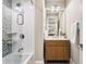 Modern bathroom with glass-enclosed shower, tiled walls, and wooden vanity at 1695 Brightwaters Ne Blvd, St Petersburg, FL 33704