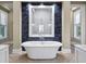 A modern bathroom features a walk-in shower, a soaking tub, and stylish tilework at 1695 Brightwaters Ne Blvd, St Petersburg, FL 33704