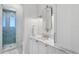 A tidy bathroom boasts marble counters, sleek fixtures, and a glass-enclosed shower at 1695 Brightwaters Ne Blvd, St Petersburg, FL 33704