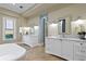 A dual sink bathroom features a modern aesthetic, with sleek white vanities and marble countertops at 1695 Brightwaters Ne Blvd, St Petersburg, FL 33704