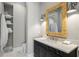Stylish bathroom featuring a modern vanity, decorative mirror, and a built-in linen closet at 1695 Brightwaters Ne Blvd, St Petersburg, FL 33704