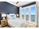 A serene bedroom offers a beautiful view of the ocean from the attached balcony at 1695 Brightwaters Ne Blvd, St Petersburg, FL 33704