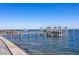 Dock view showing boat lifts and a boat sailing into the sunset at 1695 Brightwaters Ne Blvd, St Petersburg, FL 33704