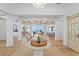 Grand foyer featuring a coffered ceiling, chandelier, wood floors, and sliding barn door at 1695 Brightwaters Ne Blvd, St Petersburg, FL 33704