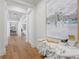 Bright hallway features wood floors, white walls, and stylish decor at 1695 Brightwaters Ne Blvd, St Petersburg, FL 33704