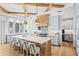 Bright, open kitchen featuring a large island, modern appliances, and coffered ceilings at 1695 Brightwaters Ne Blvd, St Petersburg, FL 33704