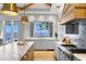 Open kitchen area with waterfront views, an island, and stainless steel appliances at 1695 Brightwaters Ne Blvd, St Petersburg, FL 33704