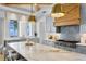 Gourmet kitchen boasts a large island, pendant lights, and a stunning waterfront view at 1695 Brightwaters Ne Blvd, St Petersburg, FL 33704