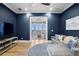Relax in this living room featuring dark blue walls, hardwood floors, and an ocean view through the doorway at 1695 Brightwaters Ne Blvd, St Petersburg, FL 33704