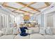 Open-concept living area featuring a coffered ceiling and open access to an eat-in kitchen space at 1695 Brightwaters Ne Blvd, St Petersburg, FL 33704