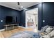Living room featuring hardwood floors, dark blue walls, and access to another living space with an ocean view at 1695 Brightwaters Ne Blvd, St Petersburg, FL 33704