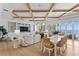 Bright living room featuring a coffered ceiling, built-in shelving, and expansive views of the water at 1695 Brightwaters Ne Blvd, St Petersburg, FL 33704