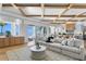 Open-concept living area with water views, beamed ceiling, hardwood floors, and neutral furnishings at 1695 Brightwaters Ne Blvd, St Petersburg, FL 33704