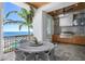 Outdoor kitchen and dining area with grill and water view, perfect for enjoying meals al fresco at 1695 Brightwaters Ne Blvd, St Petersburg, FL 33704
