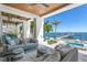 Expansive outdoor living area with water view, kitchen, pool and comfortable seating, ideal for entertaining at 1695 Brightwaters Ne Blvd, St Petersburg, FL 33704