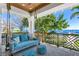 Outdoor patio featuring a comfortable swing bed overlooking serene water views and decorative railing detail at 1695 Brightwaters Ne Blvd, St Petersburg, FL 33704
