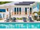 Relaxing outdoor space featuring a private pool, sun loungers, and lush landscaping creating a tranquil oasis at 1695 Brightwaters Ne Blvd, St Petersburg, FL 33704