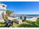Waterfront pool area with lounge chairs, fire pit, and dock access, ideal for outdoor enjoyment at 1695 Brightwaters Ne Blvd, St Petersburg, FL 33704