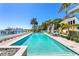 Inviting swimming pool with clear blue water, lounge chairs, and lush tropical landscaping at 1695 Brightwaters Ne Blvd, St Petersburg, FL 33704
