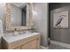 The powder room features designer wallpaper, stylish mirror, unique artwork, and mosaic-tile floors at 1695 Brightwaters Ne Blvd, St Petersburg, FL 33704