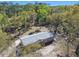 An aerial view shows a one-story house surrounded by trees at 17913 Greensboro St, Spring Hill, FL 34610