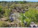 An aerial perspective shows the home surrounded by lush trees and the street at 17913 Greensboro St, Spring Hill, FL 34610