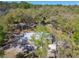 An aerial view shows this cozy home nestled amongst the trees in a wooded neighborhood at 17913 Greensboro St, Spring Hill, FL 34610