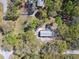 A home with a gray roof and tan siding sits nestled among mature oak trees at 17913 Greensboro St, Spring Hill, FL 34610