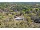 A home with a gray roof and tan siding sits nestled among mature oak trees at 17913 Greensboro St, Spring Hill, FL 34610