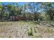 Exterior shot of the backyard with a storage container and lush vegetation, offering privacy and ample space at 17913 Greensboro St, Spring Hill, FL 34610