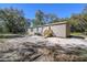 An exterior view of this home's backyard with a wood porch entry and neutral siding at 17913 Greensboro St, Spring Hill, FL 34610
