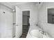 Bathroom with dual sinks, tub and shower, and neutral walls with an open doorway at 17913 Greensboro St, Spring Hill, FL 34610