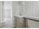 Well-lit bathroom with a view into another room, featuring a sink, vanity, and toilet at 17913 Greensboro St, Spring Hill, FL 34610