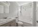 Bright bathroom with combination shower and tub unit, modern fixtures, and vanity at 17913 Greensboro St, Spring Hill, FL 34610