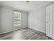 A sunlit bedroom features a window and wood-look floors at 17913 Greensboro St, Spring Hill, FL 34610