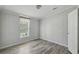 Neutral bedroom features wood-look floors, window with natural light and large closet at 17913 Greensboro St, Spring Hill, FL 34610