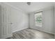 Cozy bedroom featuring wood-look floors, window with natural light, and closet at 17913 Greensboro St, Spring Hill, FL 34610