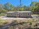 A single-story home with lots of windows and a wooden staircase at 17913 Greensboro St, Spring Hill, FL 34610