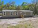 A one-story home with a neutral exterior and wood steps at 17913 Greensboro St, Spring Hill, FL 34610